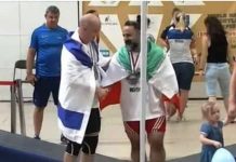 Iranian weightlifter banned for photo with Israeli Mostafa Rajai (right) shakes hands with Maksim Svirsky at the World Masters Championship in Poland. IMWA