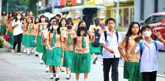 Students of the Quezon City High School troop to their school along Scout Ybardolaza Street, Barangay Sacred Heart, Quezon City. The Department of Education says more than 22.9 million students from public and private schools from kindergarten to senior high school have returned to school. PNA PHOTO