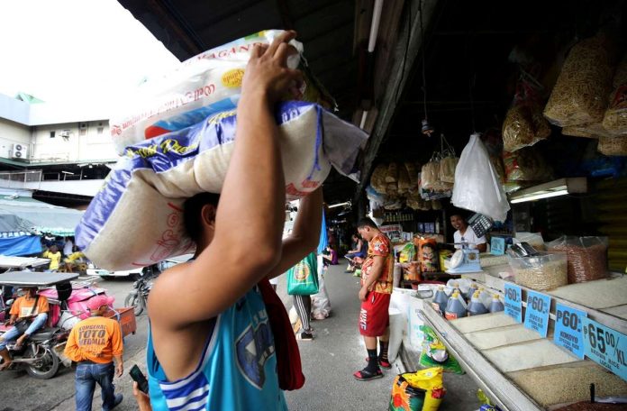 PRIME COMMODITY. Sacks of rice are delivered at a store in Commonwealth Market, Quezon City. The mandated price of regular milled rice should not exceed P41 per kilo while well-milled rice will be at a maximum of P45 per kilo starting Tuesday, Sept. 5, under Executive Order No. 39. PNA
