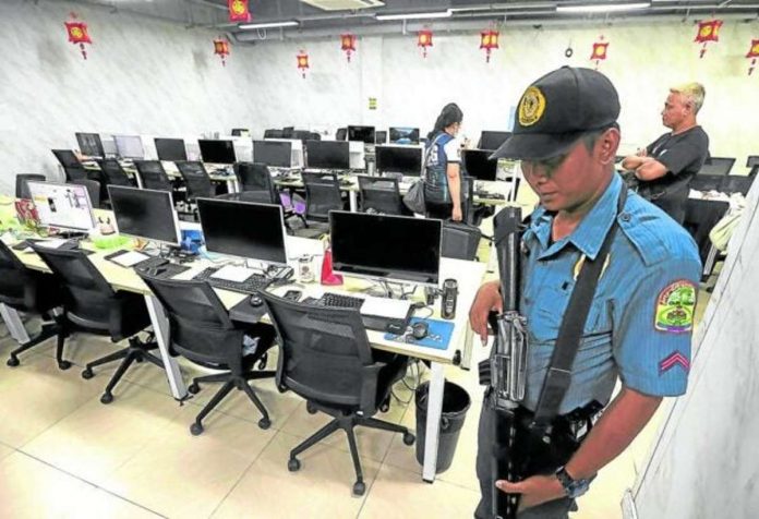 In this file photo, agents of the PNP Anti-Cybercrime Group inspect a gaming room, one of many at a suspected illegal Philippine offshore gaming operator’s hub in Almanza Uno, Las Piñas City. PHILIPPINE DAILY INQUIRER FILE PHOTO