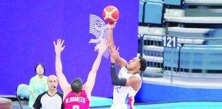 Gilas Pilipinas’ Justin Brownlee goes for a o ne-handed shot against the defense of a Bahrain player during their 19th Asian Games men's basketball game on Tuesday afternoon. PHOTO COURTESY OF POC
