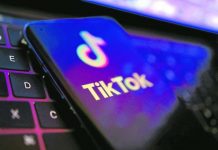Smart phone showing TikTok app start page on top of laptop keyboard. REUTERS FILE PHOTO