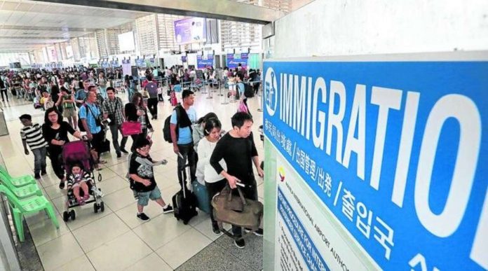 travel_resized Departing passengers line up at the immigration counters of the Ninoy Aquino International Airport before boarding their respective flights. INQUIRER FILES