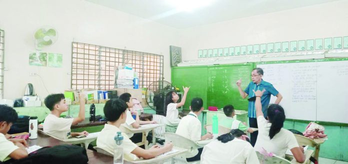 SPED_teacher_1_resized Jose Gellang teaches Grade 5 learners with hearing impairments at Special Education-Integrated School for Exceptional Children in Iloilo City. PN PHOTO