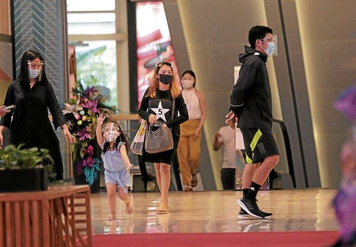 WHO_resized A child accompanied by adults wears face mask and face shield for protection from the coronavirus as they visit a mall in Quezon City. INQUIRER FILE PHOTO / GRIG C. MONTEGRANDE
