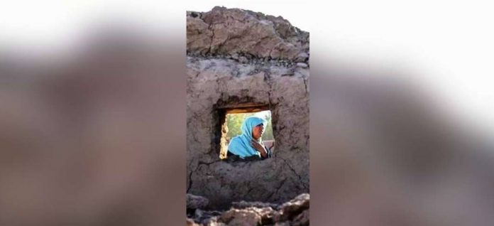 afghanistan_superimposed A woman sits behind the rubble of a building after an earthquake in Herat province, Afghanistan. EPA-EFE/REX/SHUTTERSTOCK