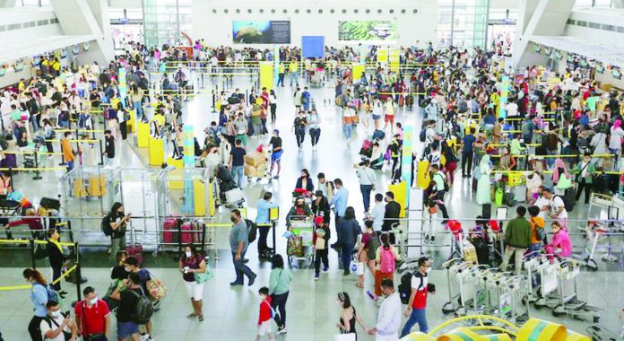 airlines.JPG_resized People fall in line at the check-in counters of the Ninoy Aquino International Airport (NAIA) Terminal 3 in Pasay City. The Manila International Airport Authority expects around 1.2 million passengers at the NAIA during the Barangay and Sangguniang Kabataan Elections and Undas break. GEORGE CALVELO/ABS-CBN NEWS PHOTO