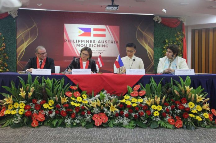 austria_hire_resized Department of Migrant Workers (DMW) officer-in-charge Hans Leo Cacdac (3rd from left) and State Secretary Susanne Kraus-Winkler (2nd from left) of the Austrian Federal Ministry for Labor and Economy sign a memorandum of understanding at the DMW Office in Mandaluyong City on Wednesday, Oct. 25. The MOU will provide employment opportunities for Filipinos while addressing Austriaâs shortage of skilled workers. DEPARTMENT OF MIGRANT WORKERS PHOTO