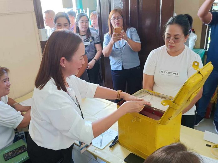 election_pic_resized The Commission on Elections says voters 18 to 30 years old would be given two official ballots – one for Sangguniang Kabataan (SK) (printed in red) and one for barangay (printed in black) for today’s barangay and SK elections. Photo shows an Electoral Board member assisting a 30-year-old voter during a mock election held at the Iloilo Central Elementary School on Oct. 26. AJ PALCULLO/PN