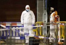 Belgian police officers search for evidence after two people were killed during a shooting in Brussels. REUTERS
