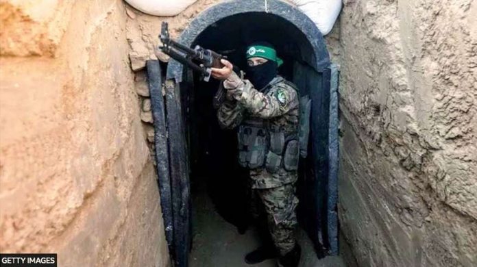 A fighter from Hamas’ military wing, the Izzedine al-Qassam Brigades, stands in front of a tunnel in the Maghazi camp, in central Gaza. GETTY IMAGES