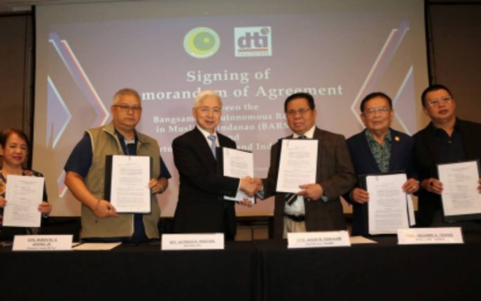 halal strategy Department of Trade and Industry secretary Alfredo E. Pascual and Bangsamoro Autonomous Region in Muslim Mindanao (BARMM) chief minister Ahod Ebrahim shake hands after signing a partnership deal with the BARMM-Ministry of Trade, Investment, and Tourism in this undated photo. The deal aims to promote Halal local goods and services provided by small and medium enterprises (SMEs) and micro SMEs. DTI PHOTO