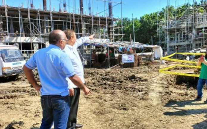 housing_board_resized Former senator Franklin Drilon (second from left) inspects on Oct. 19, 2023 the housing project at the Uswag Residential Complex in Barangay San Isidro, Jaro District in Iloilo City which funding he facilitated before he stepped down from the Senate. Lawyer Peter Jason Millare, head of the Iloilo City Local Housing Office, said a huge housing backlog is a challenge for the city government. PNA FILE PHOTO BY PGLENA