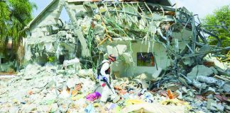 An Israeli soldier walks past a house destroyed by Hamas militants in Kibbutz Be'eri on Wednesday, Oct. 11. Two Ilongga overseas Filipino worker sisters from Maasin, Iloilo were abducted by Palestinian terror group, Hamas, in Kibbutz Be’eri on Oct. 7. The younger sibling was rescued but the elder sibling was taken by militants. ASSOCIATED PRESS PHOTO
