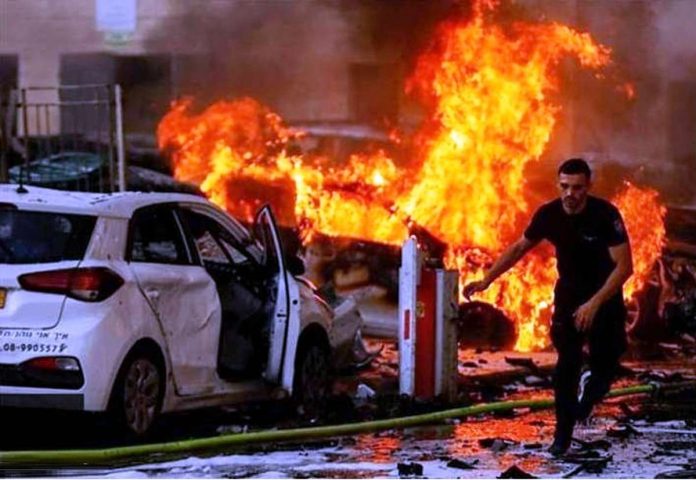 israel_resized A Palestinian man runs away from a burning building in the Gaza Strip that Israel has struck with missiles. BBC