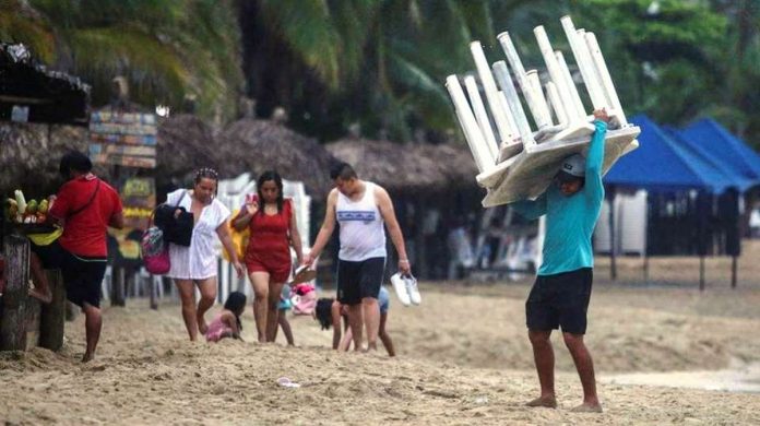 mexico_resized A man removes tables off a beach as Hurricane Otis barrels towards Acapul, Mexico. Residents in the hurricane’s path have been urged to move to emergency shelters. REUTERS