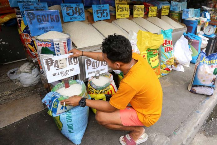 A retailer displays varieties of rice and their prices at the Trabajo Market in Sampaloc, Manila. President Ferdinand R. Marcos Jr. has lift the price caps on rice due to the decreasing rice prices in local markets and increased supply of local harvest in the last quarter of 2023. PNA PHOTO