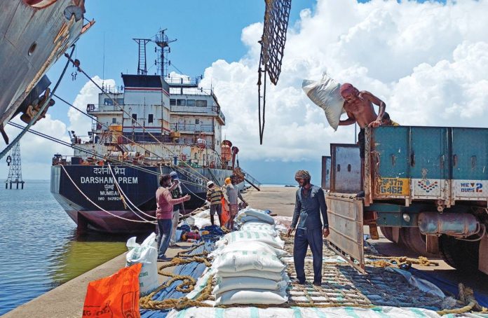 rice_shipment_resized Laborers unload rice bags from a supply truck at India's main rice port at Kakinada Anchorage in Andhra Pradesh. India would be supplying 295,000 tonnes of non-basmati white rice to the Philippines. REUTERS/RAJENDRA JADHAV PHOTO