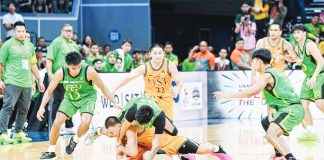 University of Santo Tomas Growling Tigers’ Nicael Cabañero protects the ball while being clobbered by Far Eastern University Tamaraws’ Royce Alforque. UAAP PHOTO