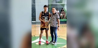 University of Santo Tomas Tiger Cubs’ Jayvee Lim receives his Most Valuable Player trophy. PHOTO COURTESY OF TINA MARALIT