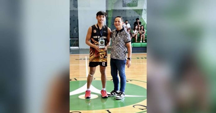 sports UST_superimposed University of Santo Tomas Tiger Cubs’ Jayvee Lim receives his Most Valuable Player trophy. PHOTO COURTESY OF TINA MARALIT