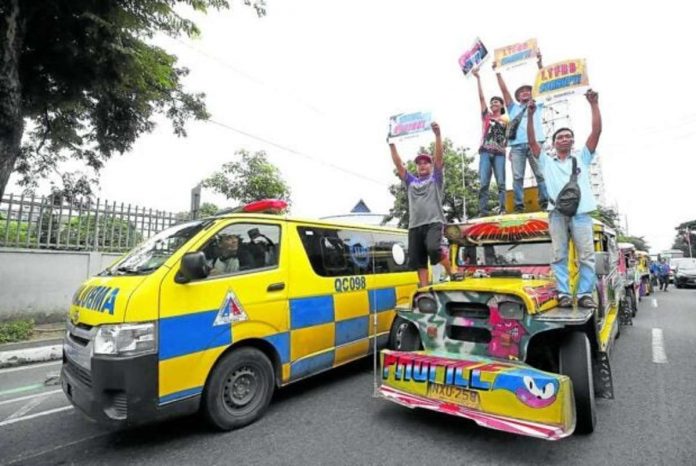strike_resized_resized Public utility vehicle drivers use a jeepney as a platform to air their grievances against the government’s transportation agencies and officials during the strike led by the group Manibela on Monday. Their protest caravan stopped on East Avenue in Quezon City before proceeding to Manila. PHOTO BY LYN RILLON, PHILIPPINE DAILY INQUIRER