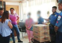 Policemen of Tubungan, Iloilo welcome the surrender of a couple (faces blurred for security reasons) who were members of the New People’s Army for seven years. At the municipal hall of Tubungan, initial reintegration assistance was released to the couple. ILOILO POLICE PROVINCIAL OFFICE PHOTO