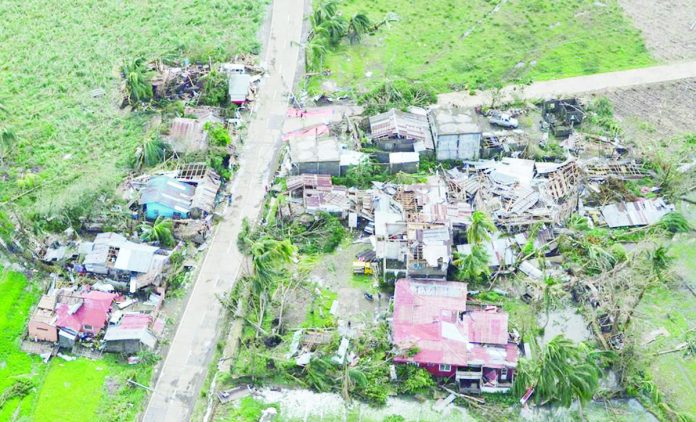 Aerial photo shows roofless houses dotting the national highway in Northern Iloilo in the wake of Super Typhoon “Yolanda” which claimed lives and devastated buildings, properties and agricultural crops. PHOTO BY JHUREEN GABALUNOS