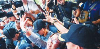 Former senator and human rights campaigner Leila de Lima waves as she leaves the Muntinlupa Regional Trial Court on Monday, Nov. 13, after being granted bail. The decision — celebrated by her supporters, colleagues, and human rights advocates — puts her a step closer to freedom after nearly seven years behind bars. "After six years, eight months and 24 days, sweet, sweet freedom. Thank you Lord," de Lima says. Philippine Daily Inquirer, Ted Aljibe/AFP