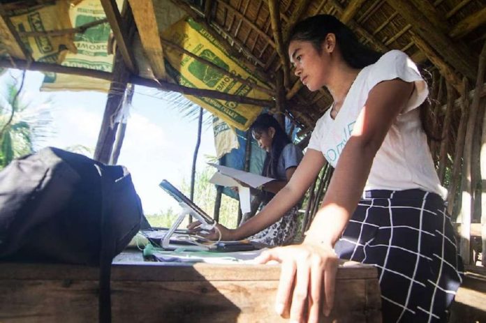 Danica Maanad and Arlotz Lacao of Suluan Island, Eastern Samar review their notes from the previous distance learning session prior their class in this file photo. ALREN BERONIO, ABS-CBN NEWS/FILE PHOTO