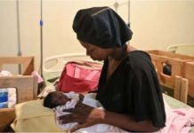 Gang violence prompts Haiti hospital evacuation A woman holds a malnourished baby at Fontaine Hospital Center, a community clinic in the impoverished Port-au-Prince shantytown of Cite Soleil. AFP