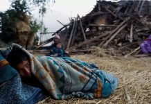Nepal earthquake: Thousands spend night outdoors in cold A boy sleeps on the floor next to a house that collapsed during an earthquake in Jajarkot, Nepal. REUTERS