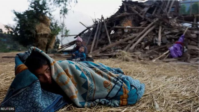 nepal_resized A boy sleeps on the floor next to a house that collapsed during an earthquake in Jajarkot, Nepal. REUTERS