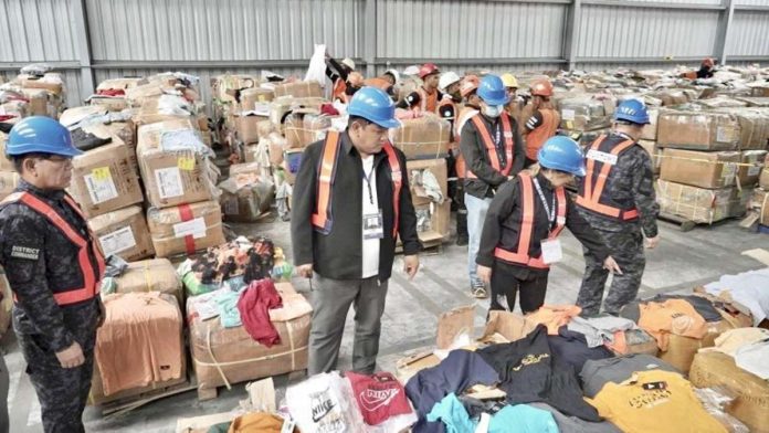 pirated_goods_resized The Bureau of Customs-Port of Subic discovered 1,269 boxes of counterfeit products bearing trademarks and copyrighted materials without authorization from the rights holders. Photo shows Customs commissioner Bienvenido Rubio (second from left) with Port of Subic district collector Carmelita Talusan (third from left) inspecting the seized goods. BOC PHOTO