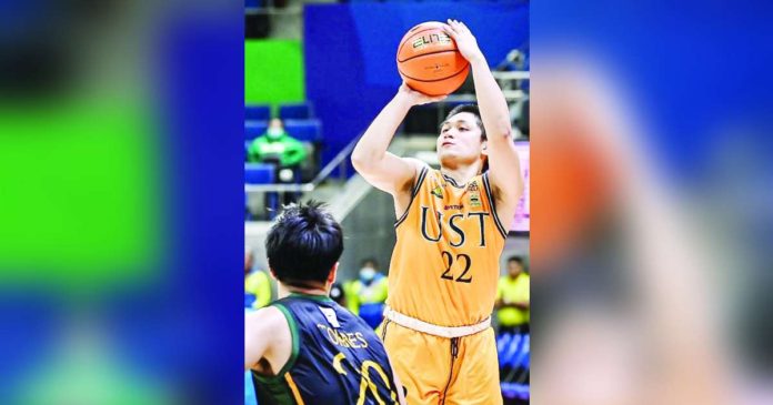 sports UST_superimposed University of Santo Tomas Growling Tigers’ Paul Manalang pulls up for a basket against the defense of Far Eastern University Tamaraws’ Xyrus Torres. UAAP PHOTO