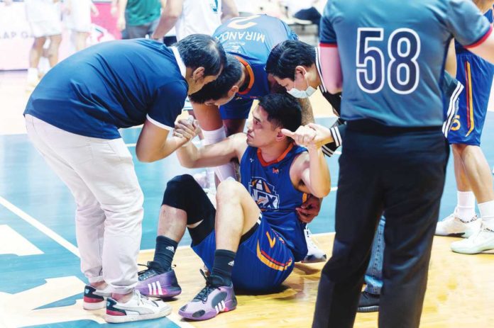 sports_NLEX_resized Kevin Alas is assisted by members of the NLEX Road Warriors following a knee injury during their game against Terrafirma Dyip. PHOTO COURTESY OF NLEX ROAD WARRIORS