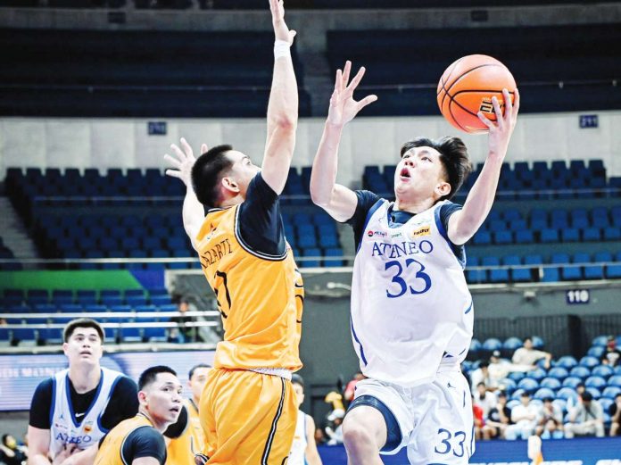 sports_Negrense_resized Negrense Raffy Celis of Ateneo de Manila University Blue Eagles attempts to score against Ivan Lazarte of University of Santo Tomas Growling Tigers. UAAP PHOTO