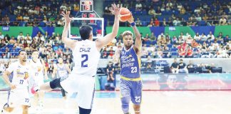 Magnolia Chicken Timplados Hotshots’ Joseph Eriobu looks to pass the ball after being bothered by the defense of TNT Tropang Giga’s Carl Bryan Cruz. PBA PHOTO