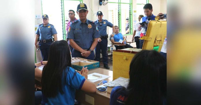 tax_superimposed Poll workers at the Daniel R. Aguinaldo National High School in Talomo, Davao City wait for voters as policemen look on during the conduct of the barangay and Sangguniang Kabataan elections on Oct. 30, 2023. PNA