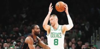 Boston Celtics center Kristaps Porzingis (8) sets to drive against Detroit Pistons guard Alec Burks. AP PHOTO/CHARLES KRUPA