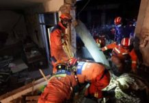 Over 120 killed in deadly China quake Rescuers in orange outfits checked this earthquake-damaged building in Kangdiao village in Jishishan county. REUTERS