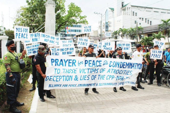 ex_rebels_(2).JPG_resized Former rebels of the New People’s Army hold a rally in front of the Iloilo Provincial Capitol in Iloilo City yesterday, Dec. 26. AJ PALCULLO/PN