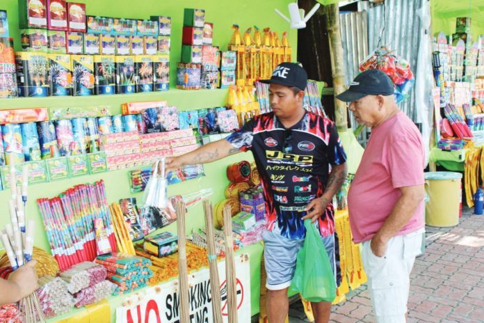 firecrackers_pic.JPG_resized A firecracker vendor attends to a customer at his stall on Circumferential Road 1, Barangay Buhang, Jaro, Iloilo City. This area, one of the city’s three authorized locations for firecracker and pyrotechnic sales, draws a diverse crowd of locals and visitors, all eager to partake in the festive spirit with their purchases. AJ PALCULLO/PN