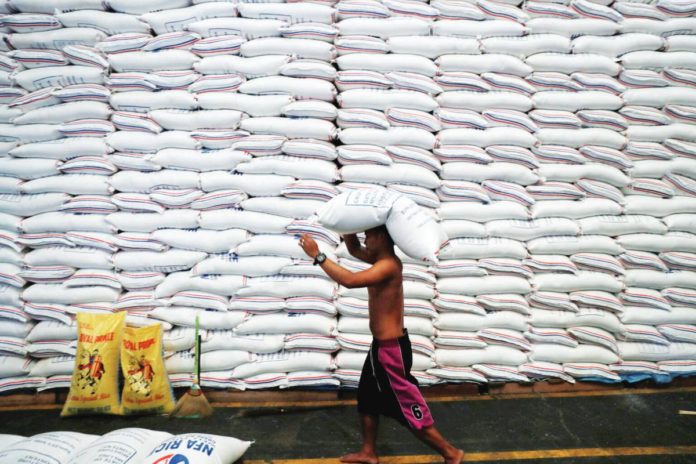 import_rates_resized A worker carries a sack of rice on his head inside a government rice warehouse National Food Authority in Quezon City. REUTERS/ERIK DE CASTRO/FILES