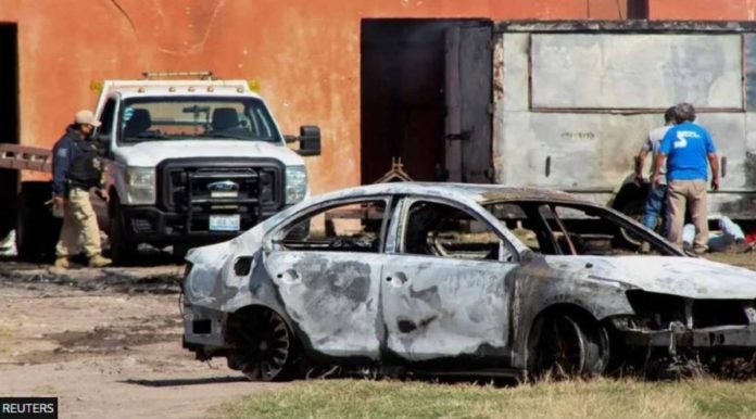 mexico_resized The burnt wreckage of a car stands at the scene where members of an armed group opened fire to partygoers attending a posada, in Salvatierra, in Guanajuato state, Mexico. REUTERS