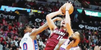 Miami Heat rookie Jaime Jaquez Jr. attacks the defense of Philadelphia 76ers' Tyrese Maxey and Marcus Morris Sr. for an inside hit. PHOTO COURTESY OF LYNNE SLADKY/AP