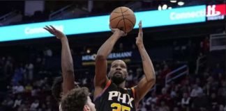 Phoenix Suns' Kevin Durant pulls up for a basket against two Houston Rockets' defenders. PHOTO COURTESY OF KEVIN COX/AP PHOTO