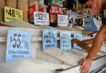 Gov’t eyes rice vouchers for poor families A market vendor waits for customers in front of their rice and grains store inside public market in Quezon City. GEORGE CALVELO, ABS-CBN NEWS/FILE PHOTO