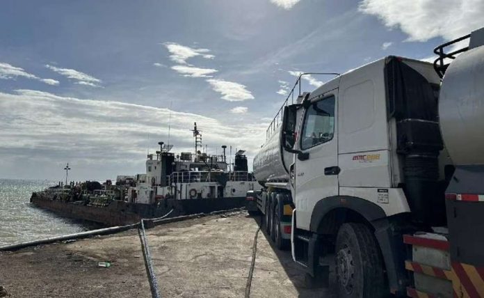 smuggled_fuel.JPG_resized This Dec. 17, 2023 photo shows trucks and a motor tanker that personnel of the National Bureau of investigation and Bureau of Customs seized in Mariveles, Bataan. ABS-CBN NEWS/JOB MANAHAN PHOTO