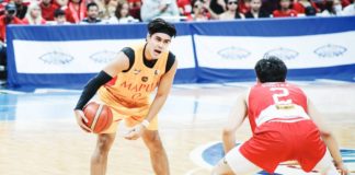 Mapua University Cardinals’ Clint Escamis holds the ball while being defended by San Beda University Red Lions' Jacob Cortez. NCAA/GMA SPORTS PHOTO